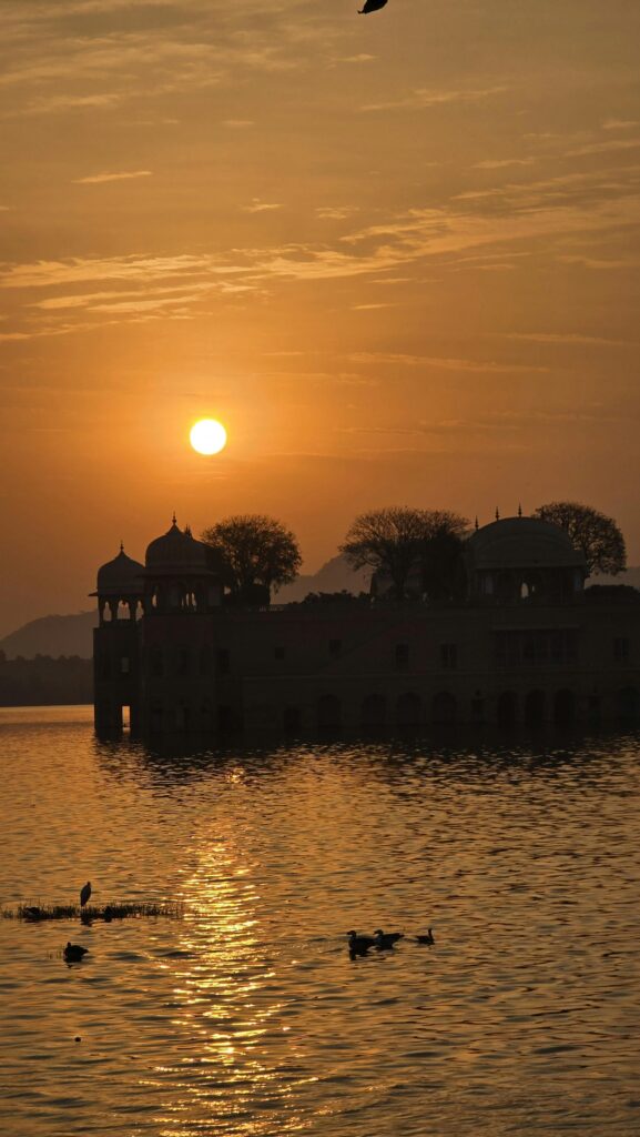Serene sunset view of Jal Mahal reflecting on Man Sagar Lake in Jaipur.